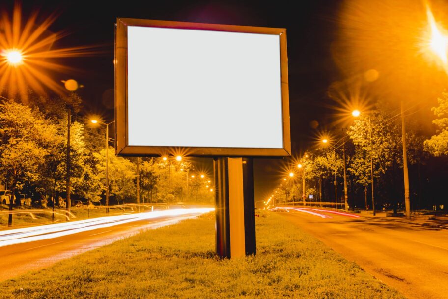 blank-advertisement-billboard-with-light-trails-downtown-district-night
